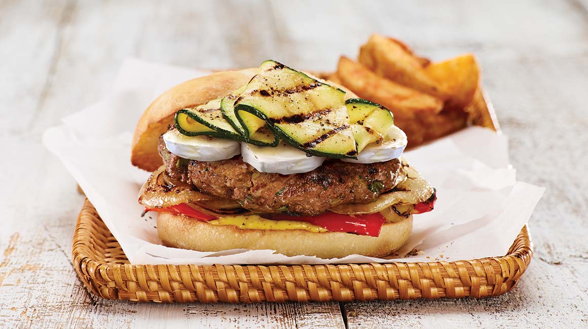 Beef burger with grilled vegetables and goat cheese