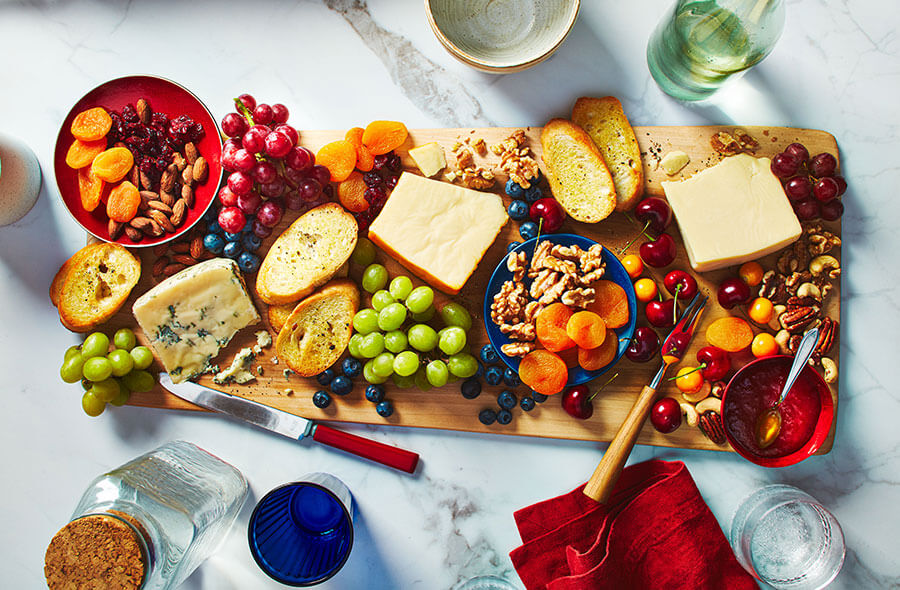 /content/dam/empire/safeway/assets/images/uploads/2025/05/Wooden-board-with-wedges-of-cheese.jpg